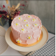 Pastel Pink Swash Cake with Piped Daisies